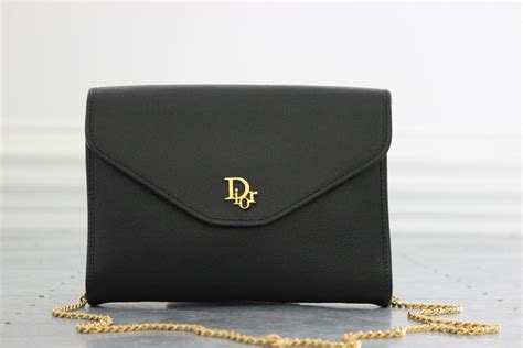 dior clutch with hand strap.